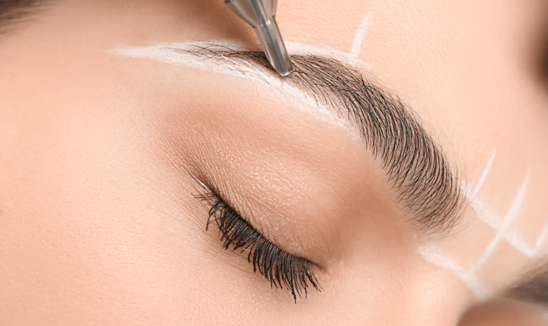 A female client undergoing the brow mapping process for permanent makeup in Oklahoma City, with prec