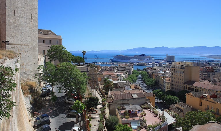 Cagliari city with cruise ship and mountains in distance