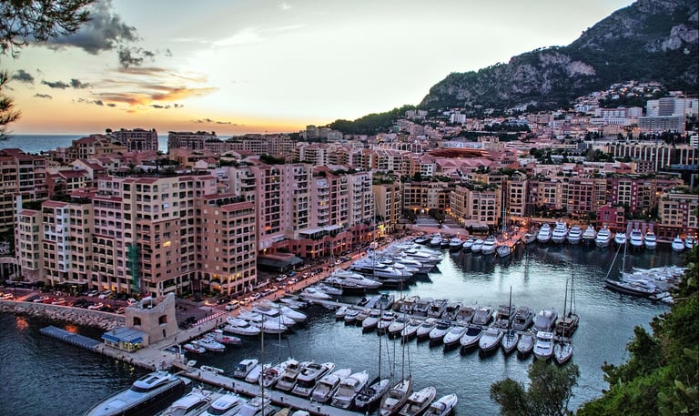 boats in Port of Cannes with buildings at sunset