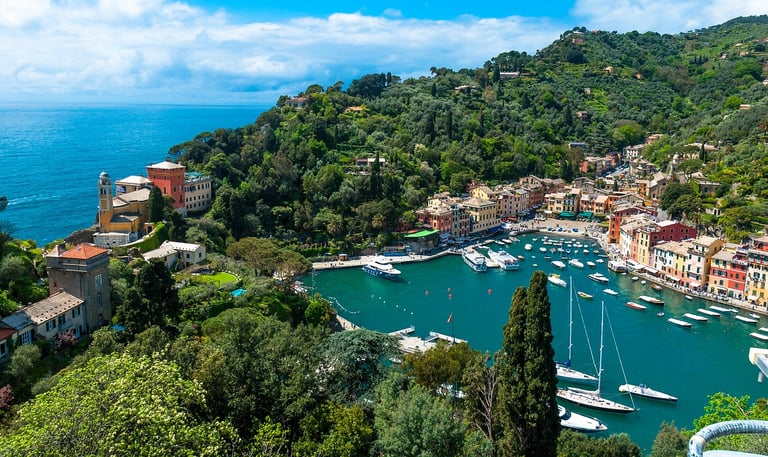 Portofino Arial with water with boats and buildings next to ocean