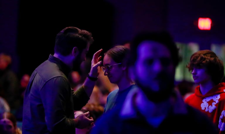 Pastor applying ashes to a congregants forehead
