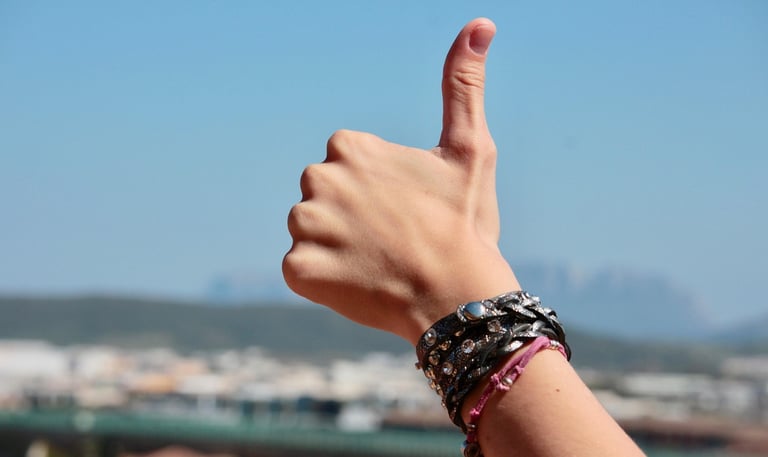 photo of a thumb up with a blue background