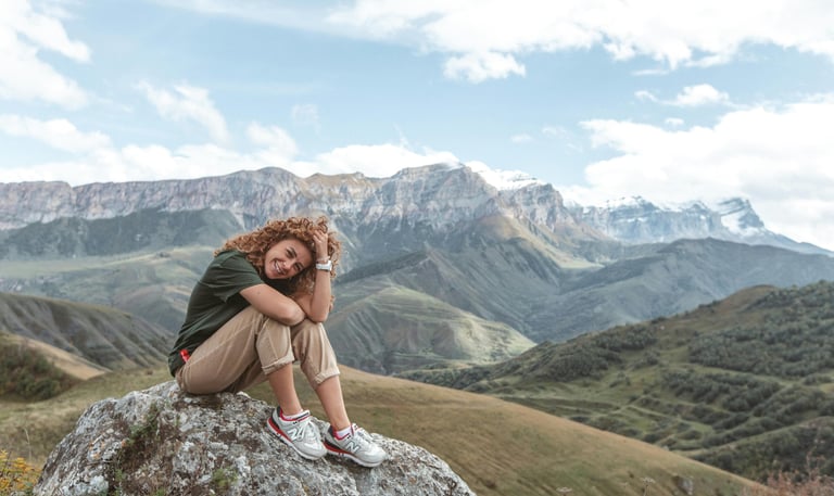 Woman sitting in mountain landscape