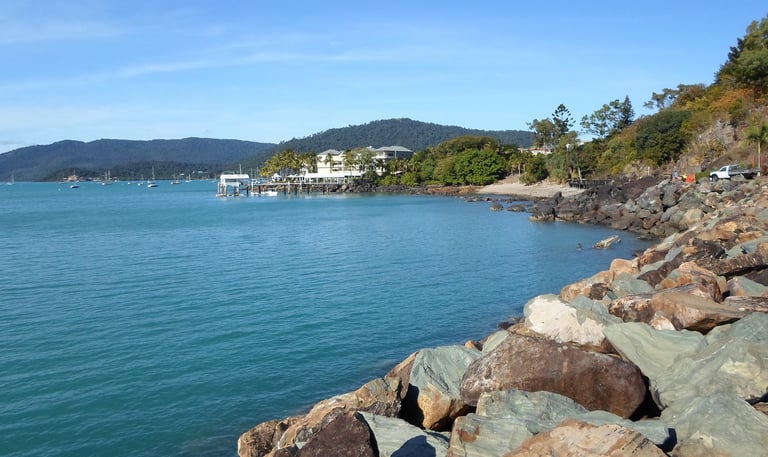 Airlie Beach rocky coast with resort in distance