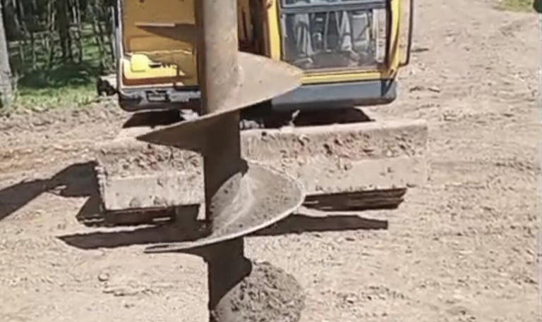 a construction worker is working on a pile of rocks