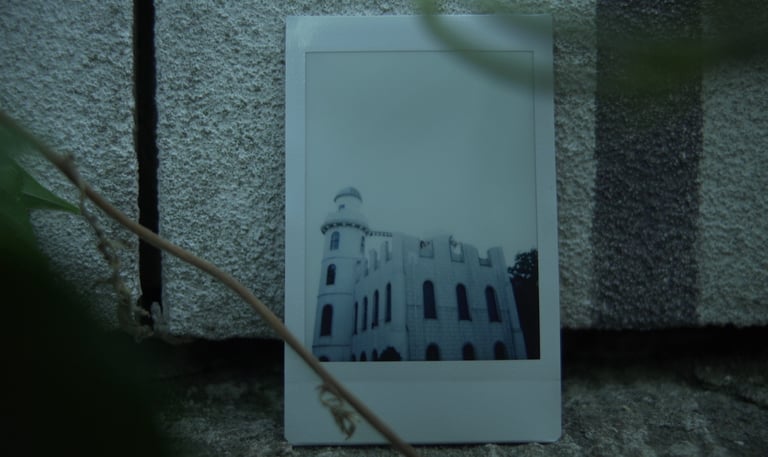 Photograph of a white castle placed against a stone wall, still from Nostalgia by Tina Bikic.