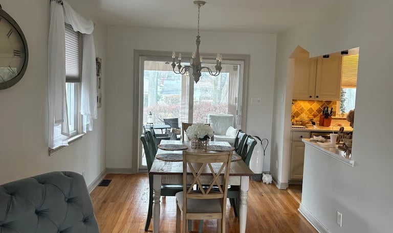 a finished painted dining room with a table and chairs