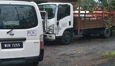 a truck with a trailer parked in front of a house