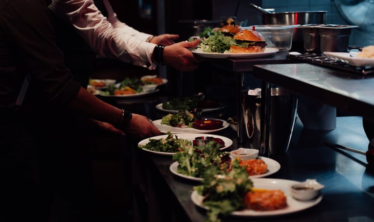 a man is serving food to a woman in a restaurant