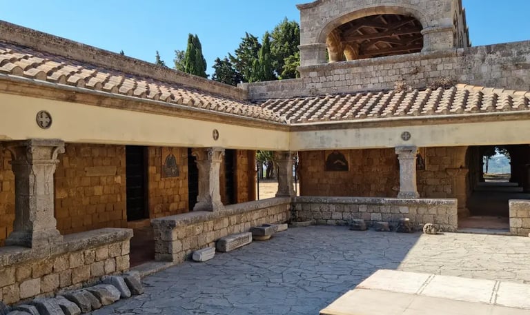 Stone courtyard and ancient architecture of the Filerimos Monastery in Rhodes, Greece.