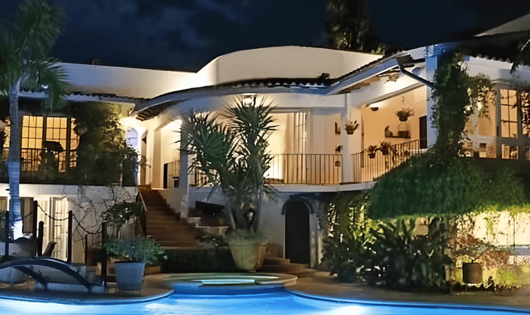a magnificent villa with a pool and terraces at night