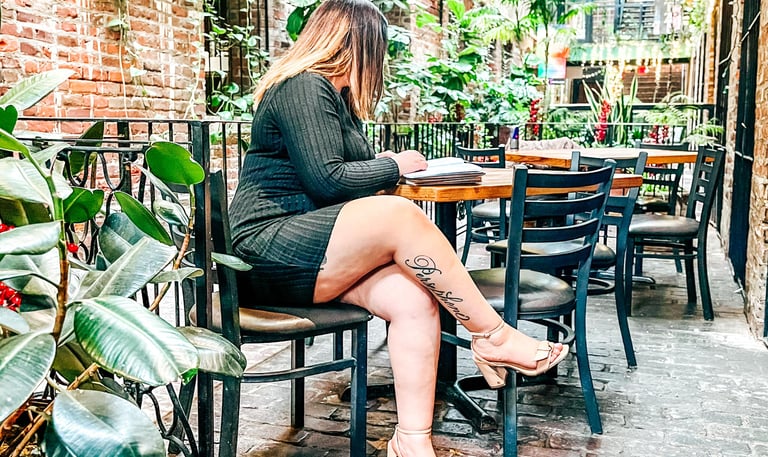 Business owner sitting at a table reading a book