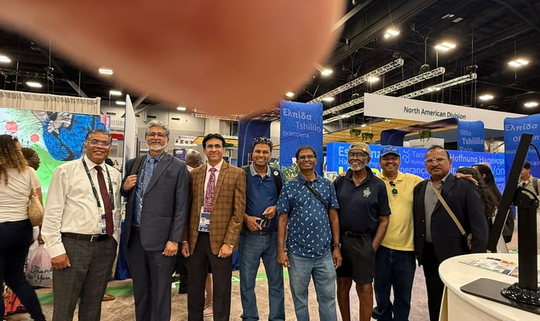 a group of people standing around a table
