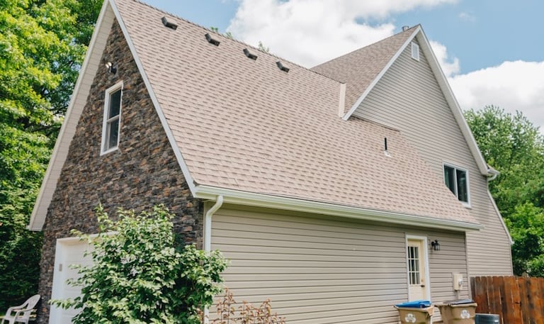 house with a brown shingle roof