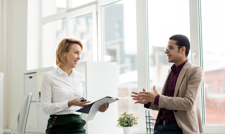 a man and woman in business attire talking to each other