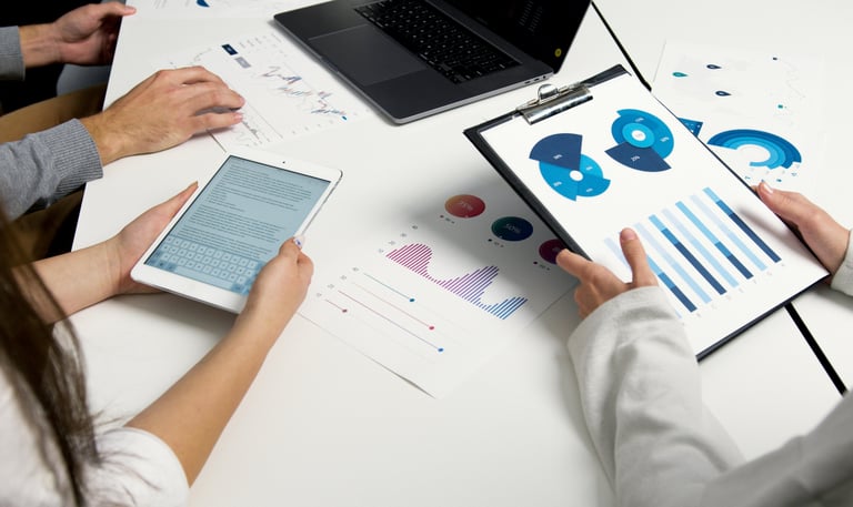 a group of people sitting at a table with papers and papers