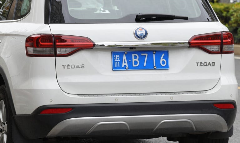 A busy city intersection with people crossing and vehicles waiting at traffic lights.