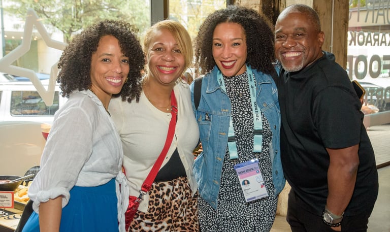 A group of four smiling diverse professionals networking during SXSW EDU 2026
