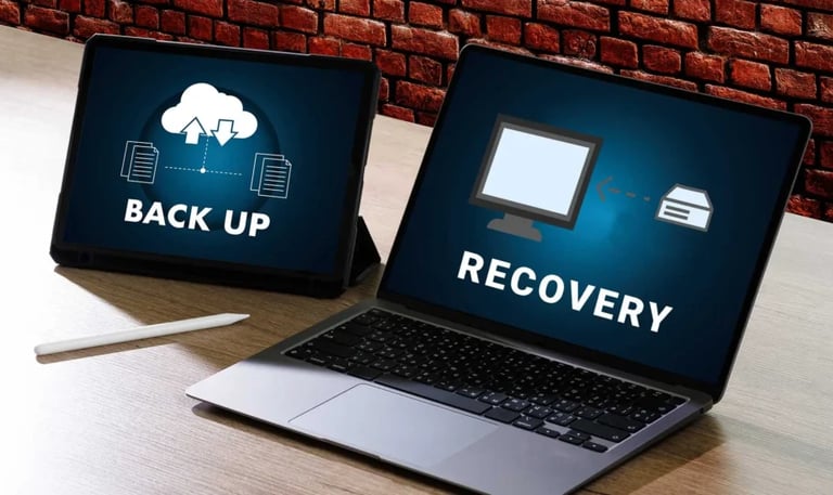 A laptop and tablet displaying data backup and recovery icons for cloud storage services.