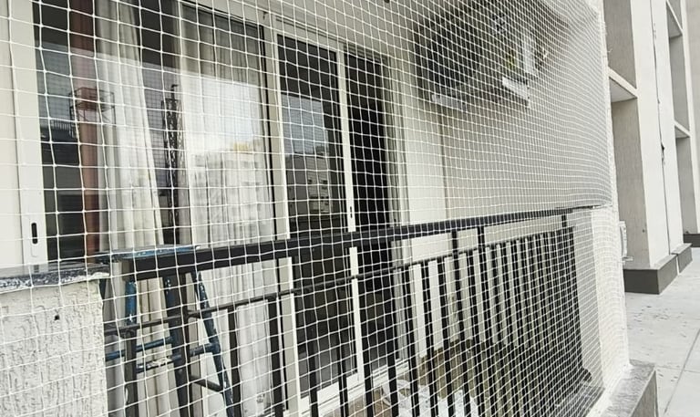 Wide shot of a residential building in Thane East featuring newly installed safety nets on all balco