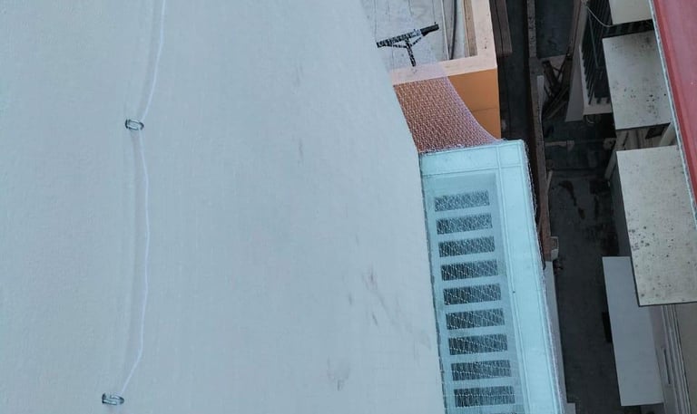 duct area covered with a tightly secured pigeon safety net in an apartment complex.