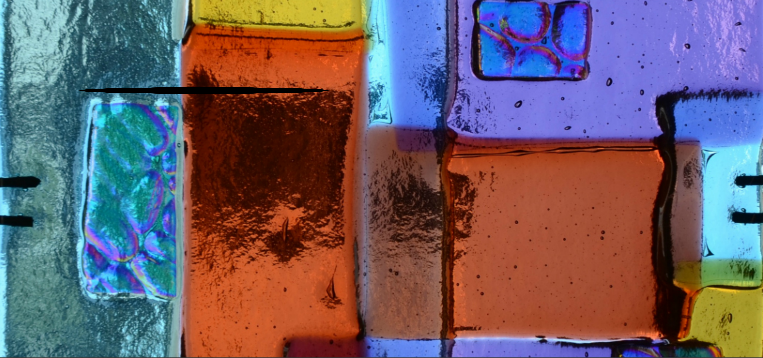 Colorful fused glass art with reds, oranges, greens and yellows