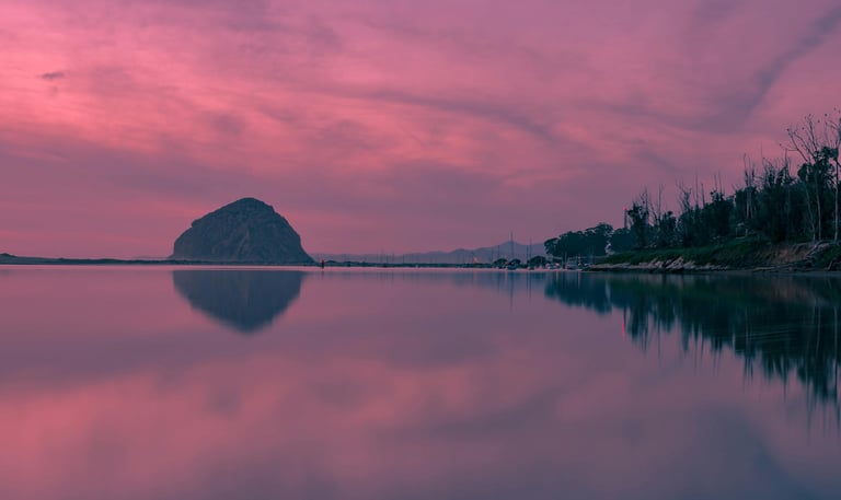 A shot of dusk over a calm lake, representing the transition into rest and restoration.