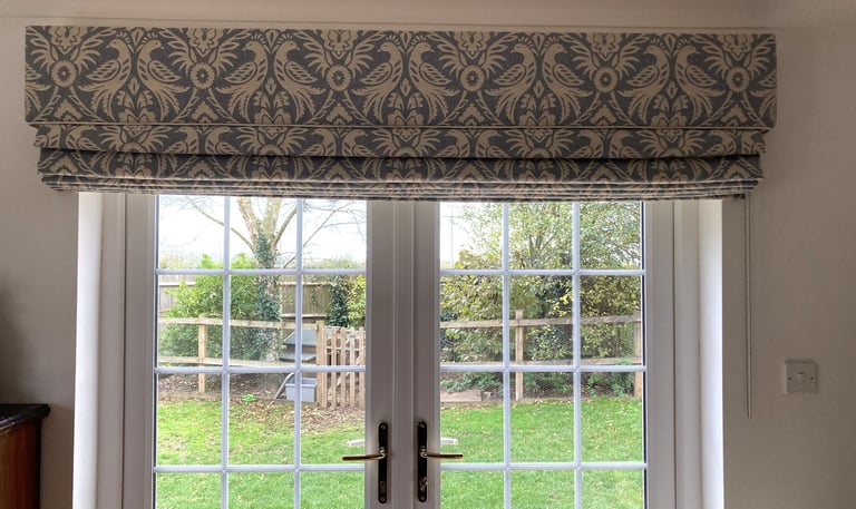 A large blind with a solid fabric in the same fabric which is carefully pattern matched