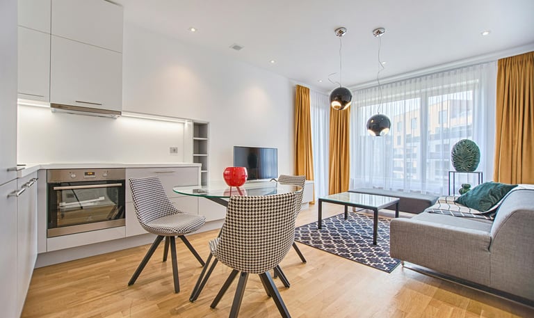 a living room with a table and chairs