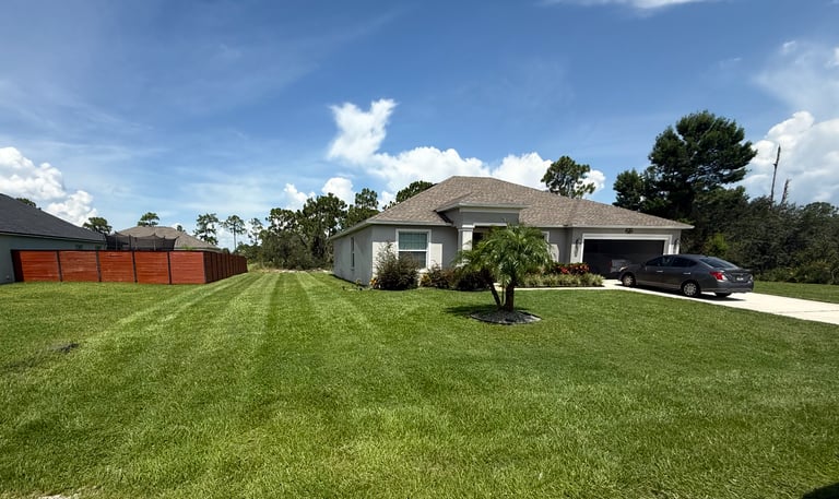 a house with a car parked in the grass