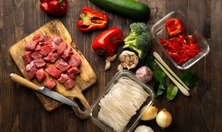 a cutting board with a knife and a knife and some vegetables
