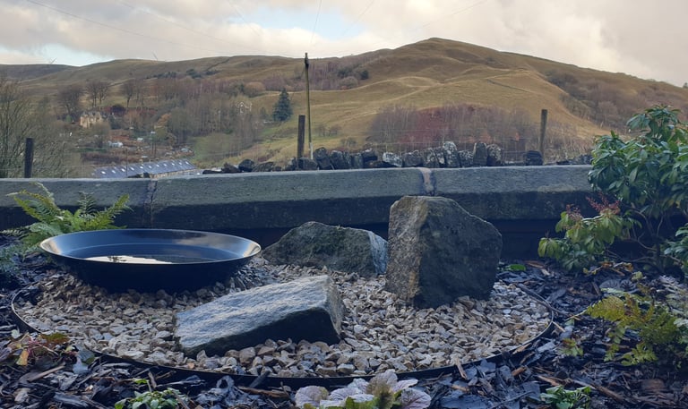 A garden design in Todmorden, West Yorkshire featuring three landscape rocks and a water bowl 