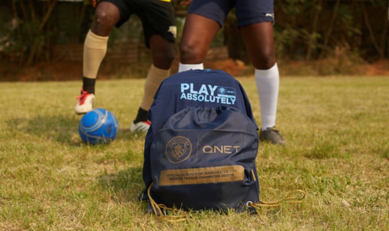 a backpacker playing soccer in a field