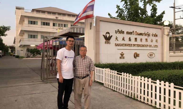two men standing in front of a sign that says,