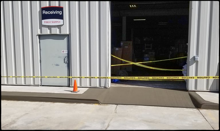 Concrete curb, and loading dock approach.