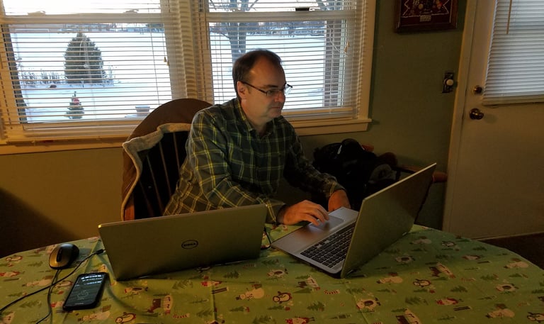 Tim Scott working on two laptops at the same time
