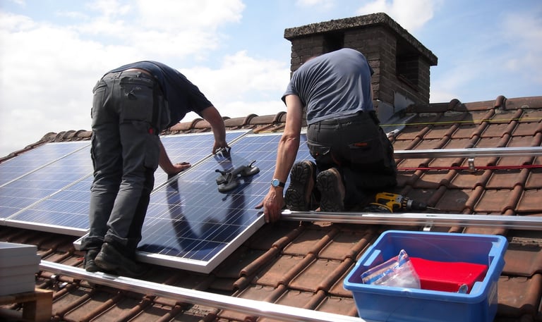 two men working on a solar paneled roof