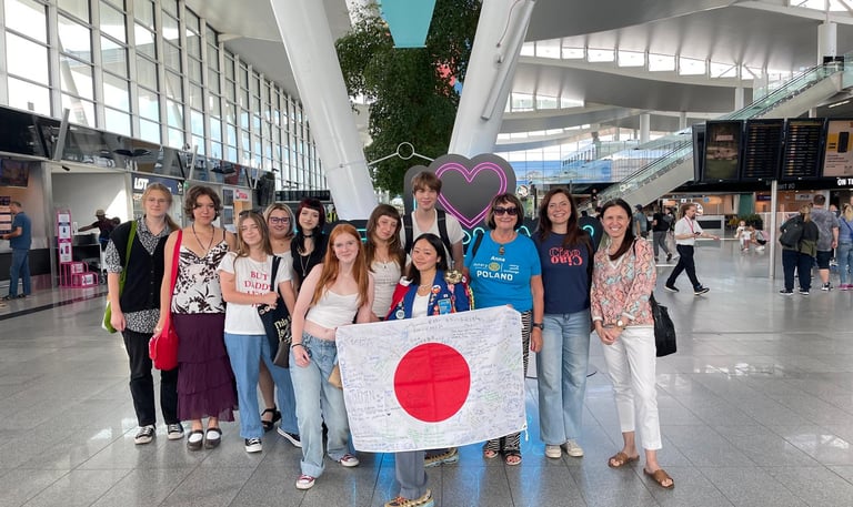 a group of young people standing in a lounge or Wroclaw airport
