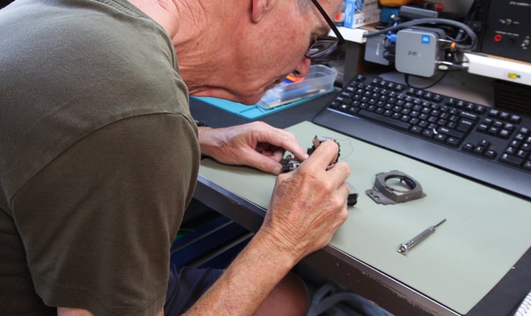 Camera technician repairing Nikon camera