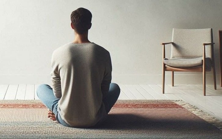 A person sitting down to practice meditation
