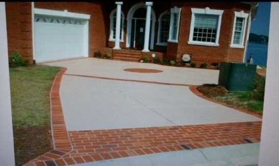 a brick house with a driveway with a driveway with brickwork
