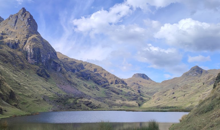 a mountain scene with a lake and mountains in the background