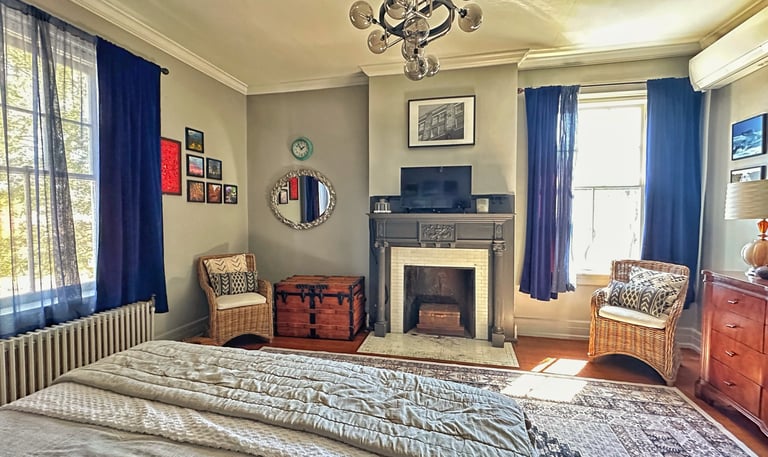 bedroom with fireplace and chandelier 2123 rivermont apartments