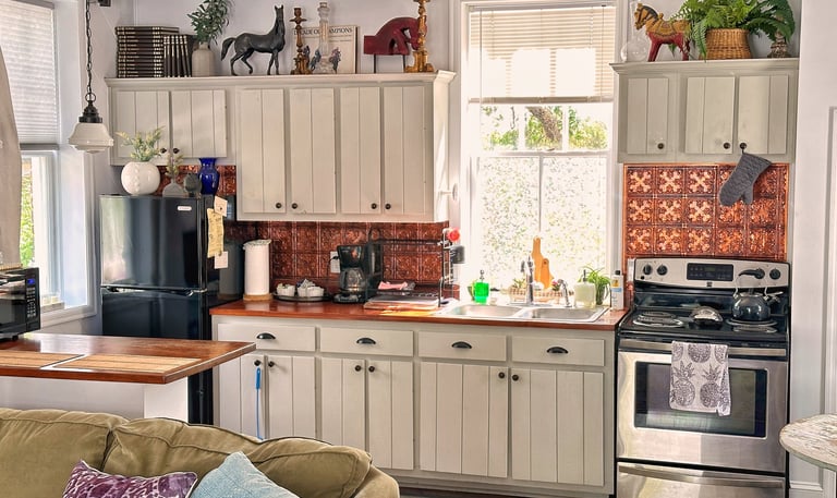 galley kitchen with gray cabinets and stainless steel appliances 2123 rivermont carriage house