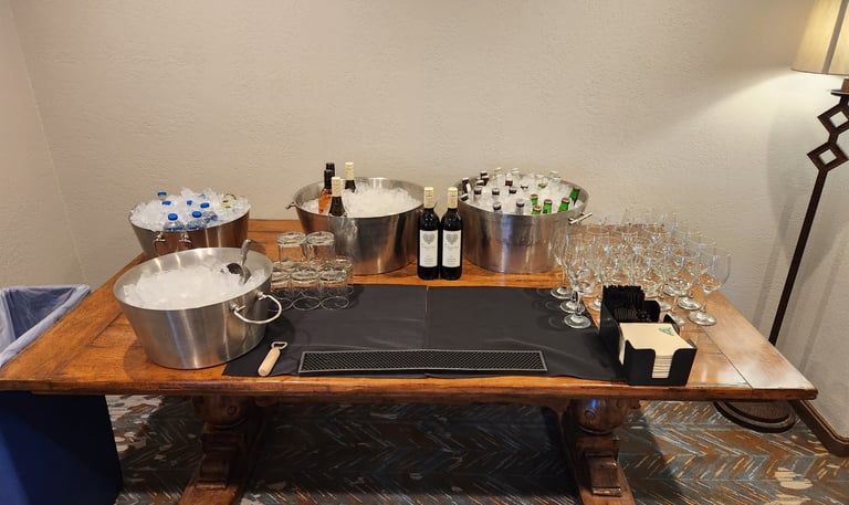a table with a wine glass and a bucket of wine glasses