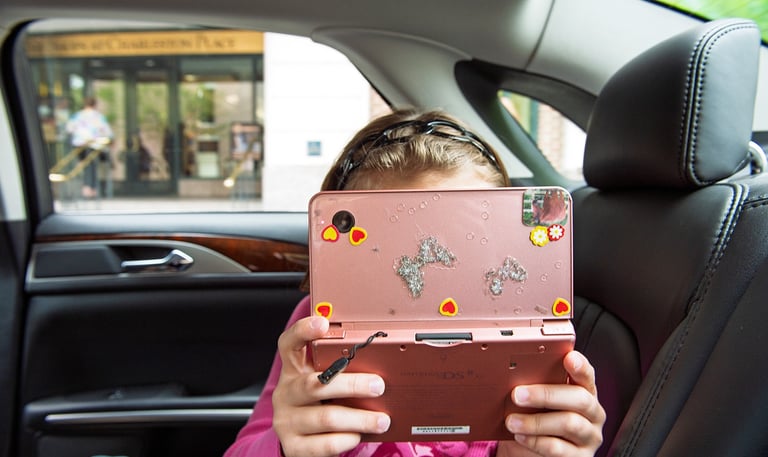 a young girl holding a pink camera in her hands
