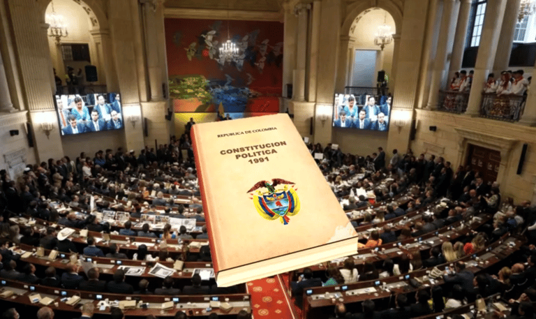 The 1991 Political Constitution of Colombia book overlaid on a crowded Colombian Congress session.
