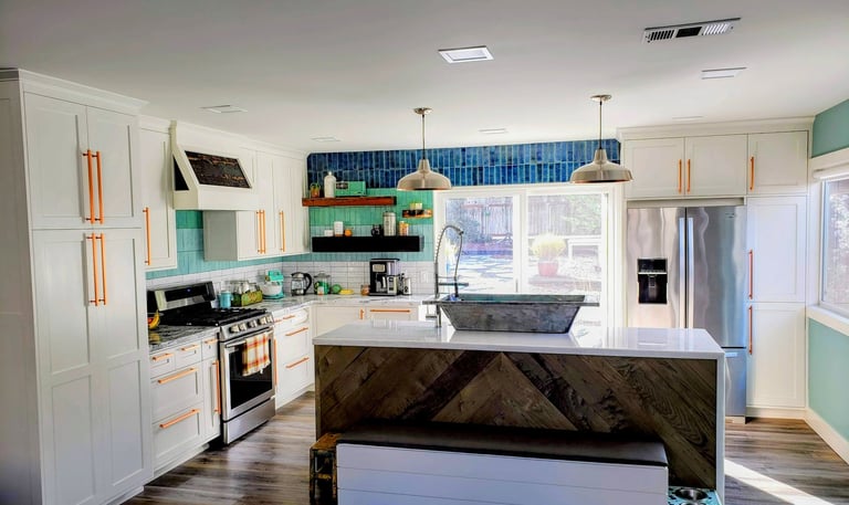 modern smart kitchen with waterfall island counter.  Custom French bath sink, storage bench, and built in dog bowl area.