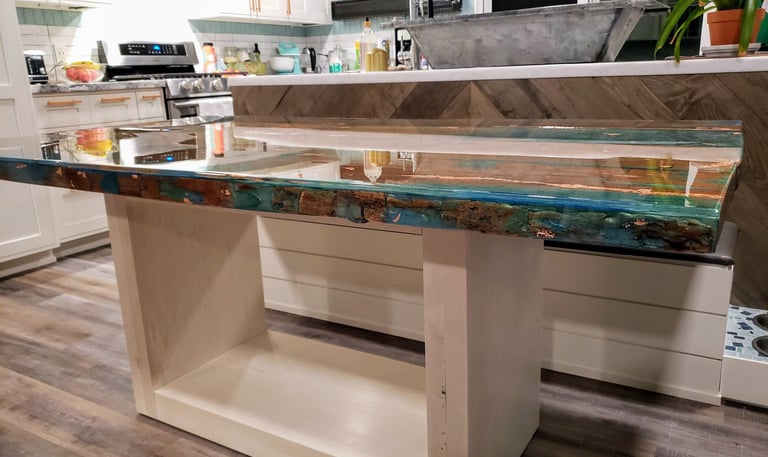 custom dinner table with colored epoxy with gold flecks and reclaimed wood with a maple wood base. Colorado Springs kitchen.