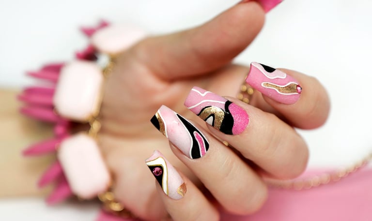 a woman's hand painted nails and nails with a pink and black nail polish